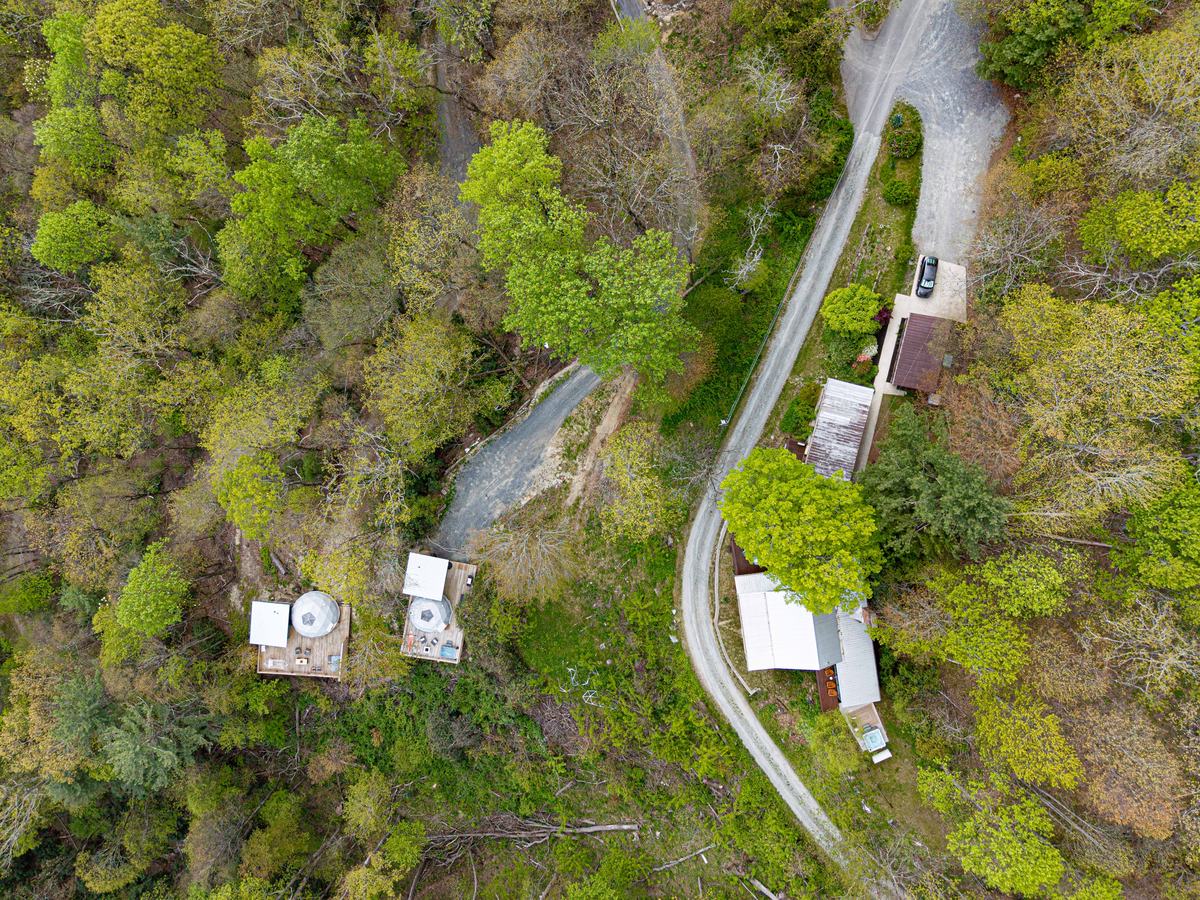 Aerial view of The Orchard — domes, cabins, and 20 private acres