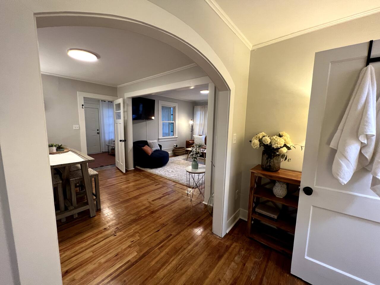 Open-concept living room with arched doorway