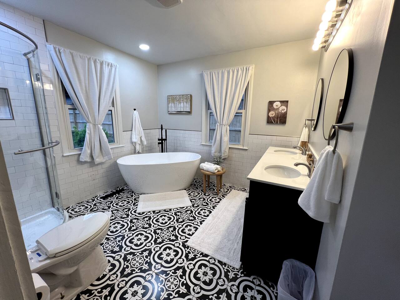 Five-piece primary bathroom with double vanity and tiled shower