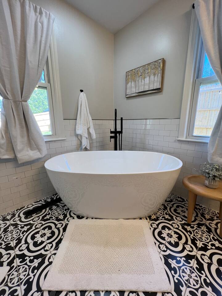 Free-standing soaking tub in the primary bathroom