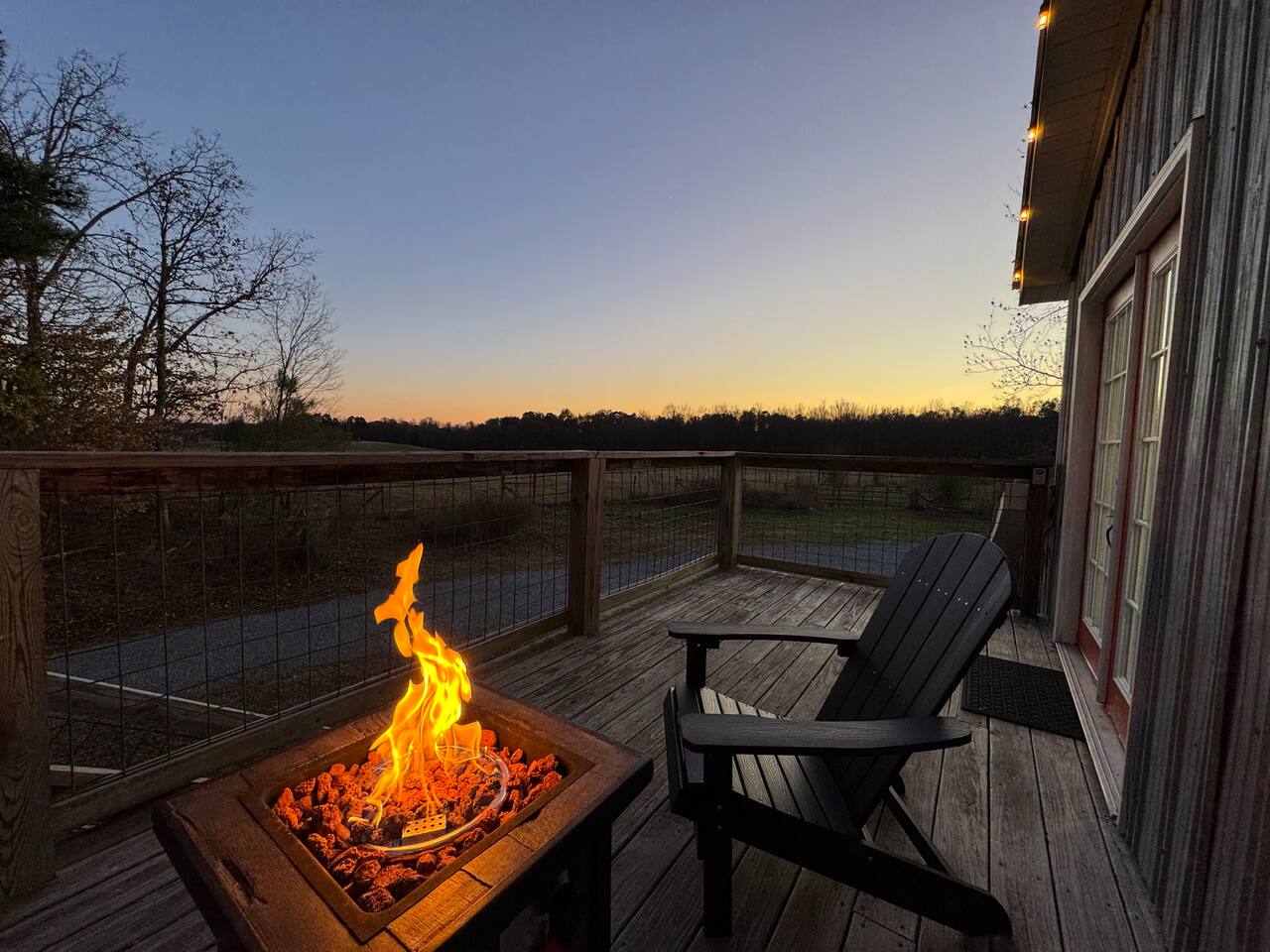 Fire pit burning on the Barn Suite deck at sunset
