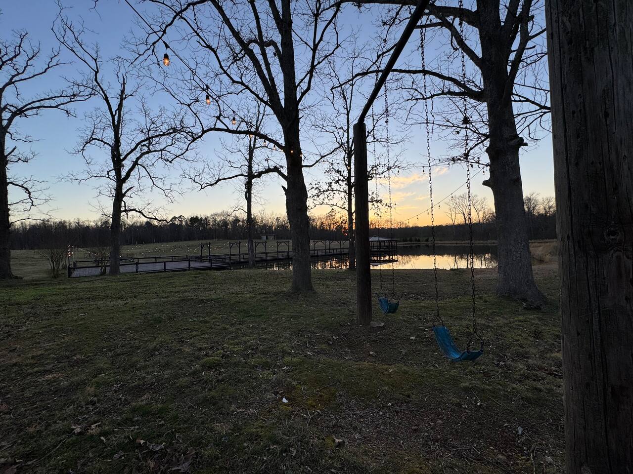 Open fields and trees running down to the water