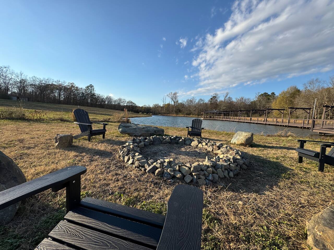 Stone fire pit ring beside the pond