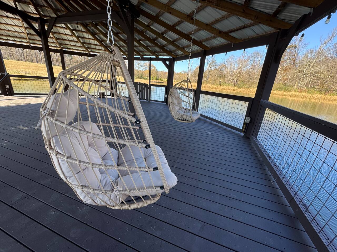 Gazebo over the water with swinging egg chairs