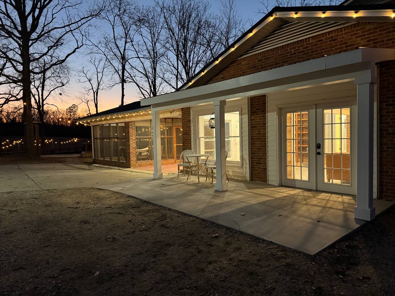 Covered porch lit at dusk