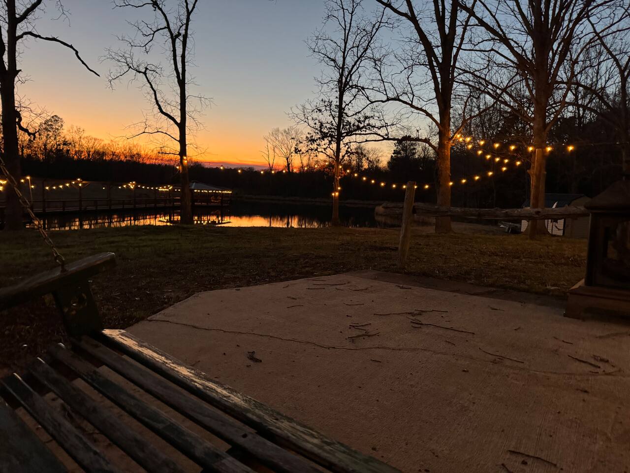 Sunset over the pond with string lights