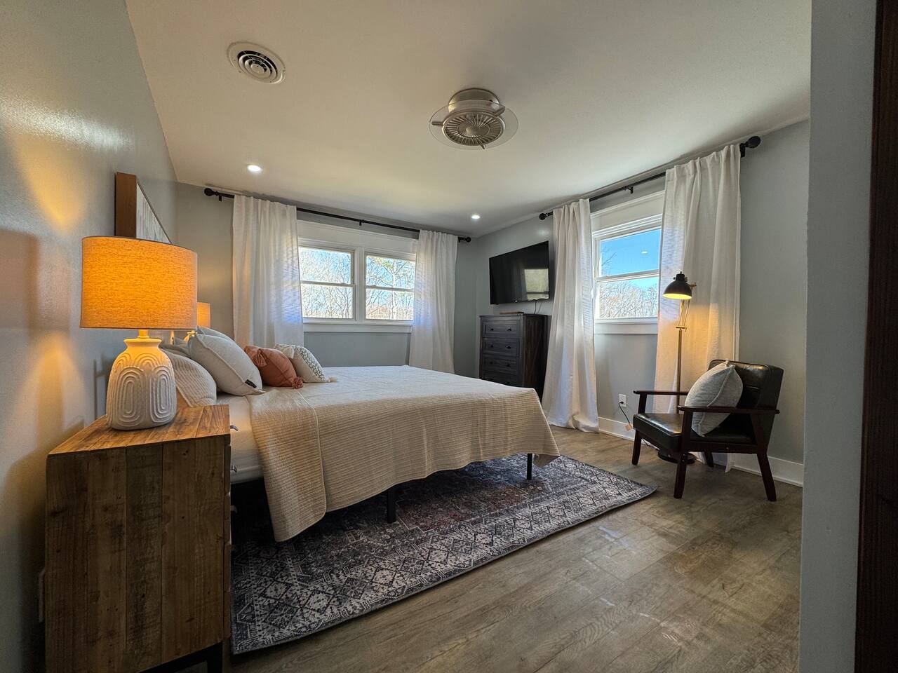 Main House bedroom with a TV and reading chair