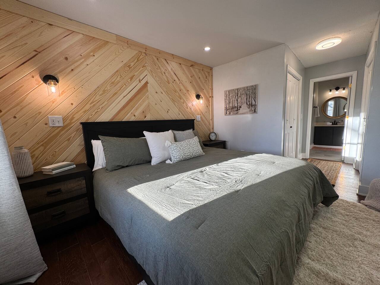 Main House king suite with a chevron wood wall and en-suite bath