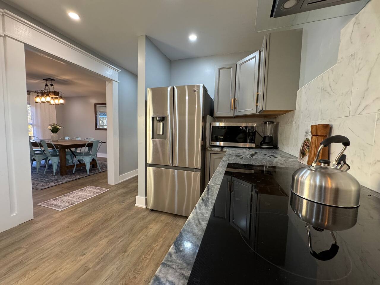 Main House kitchen with granite counters and marble tile backsplash