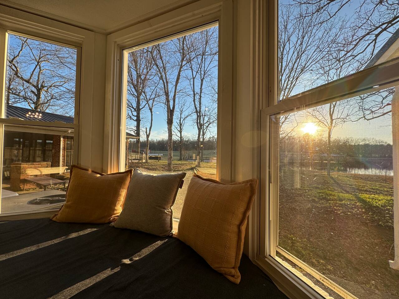 Main House window seat looking over the fields and pond at sunset