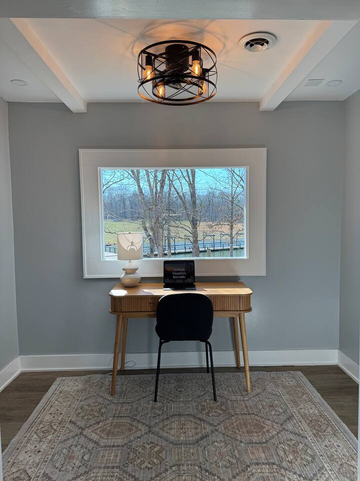 Main House desk under a picture window over the fields