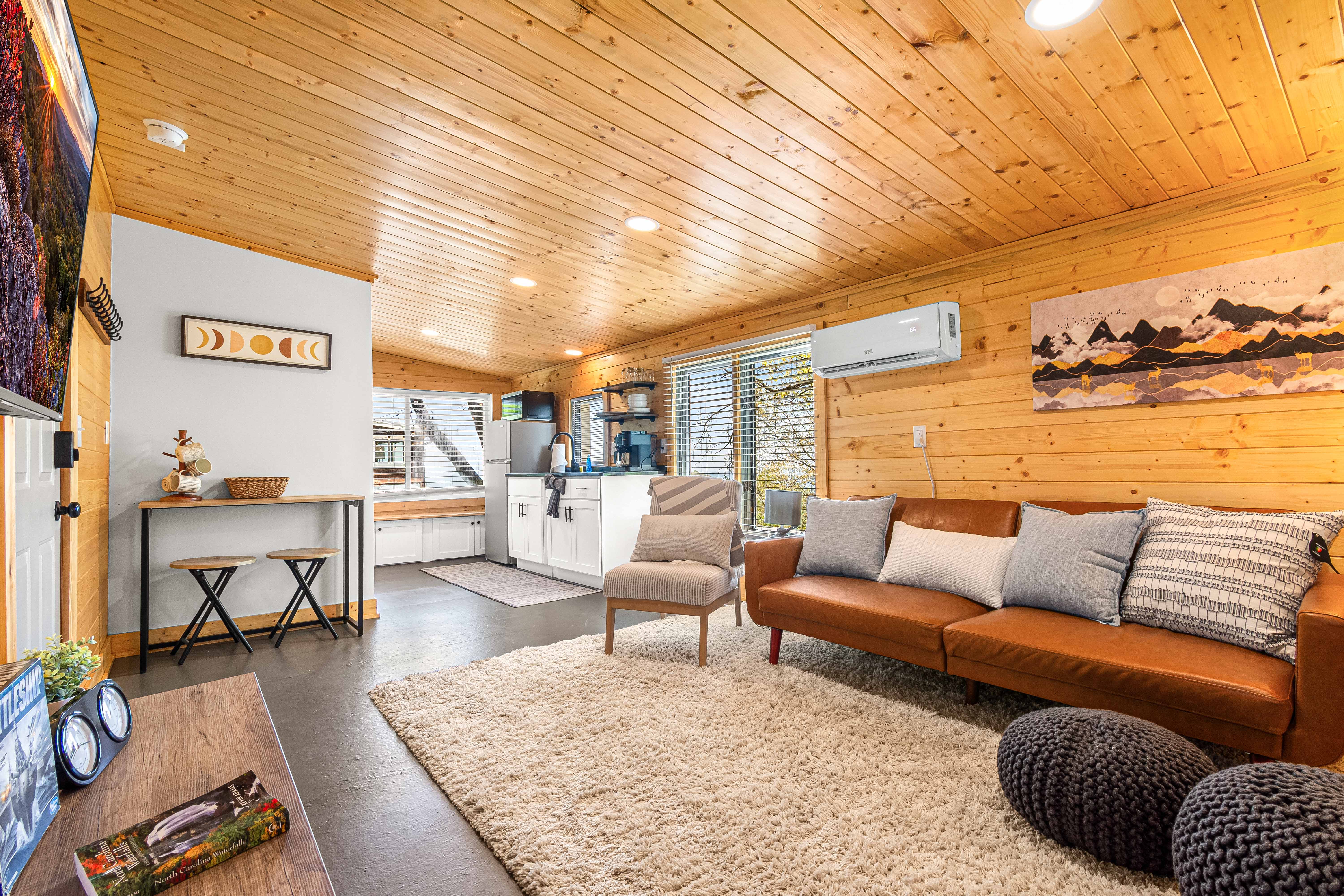 Tiny Cabin living area with sleeper sofa and window nook